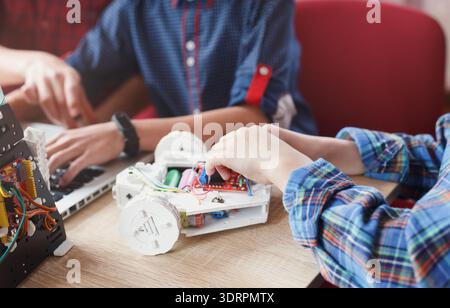 Students Work on a Robotics Project at a Learning Center in an Afternoon Session Stock Photo