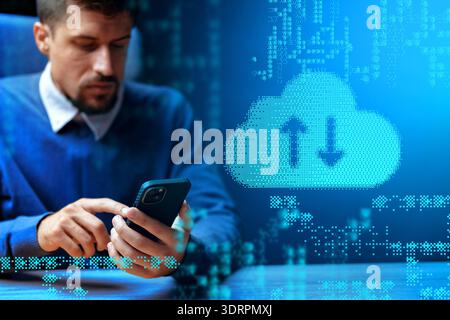 Man using smartphone to transfer data in digital workspace on a workday afternoon Stock Photo