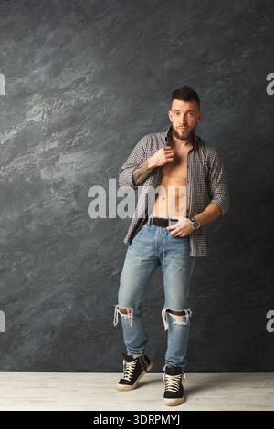 Collage of a Man in Casual Clothes Standing Against a Dark Wall in a Studio Setting Stock Photo