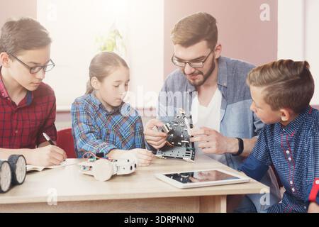 Students Learn About Robotics and Engineering Through Hands-On Project Work in a Classroom Setting Stock Photo