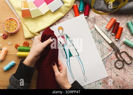 Crafting a Fashion Design With Fabric Swatches and Sketches Showing Creative Process in Action Stock Photo