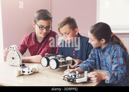Students Engage in Robotics Activities at a Learning Center During a Daytime Workshop Stock Photo