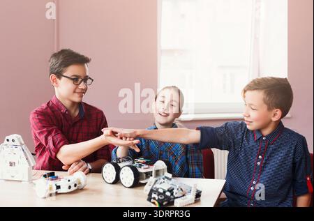 Kids Engage in Robotics Project and Collaboration at School During a Creative Workshop Stock Photo