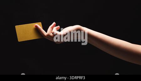 Hand Holding a Yellow Card Against a Dark Background in a Creative Collage or Set Stock Photo