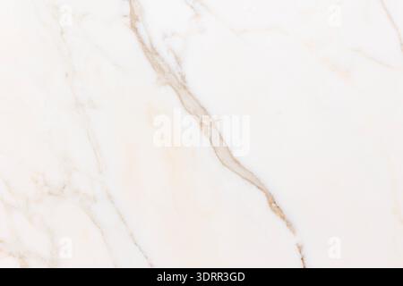 The image shows a close-up of a white marble surface with natural beige and gray veining. The organic lines create an elegant and minimal pattern, hig Stock Photo