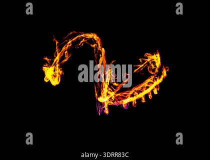 a long-exposure photograph of a fire performance, where a skilled performer spins flaming props like poi to create mesmerizing light trails and intric Stock Photo