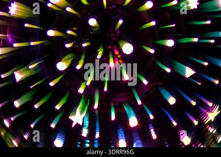 an abstract photograph capturing the effect of colorful lights within a mirrored environment, likely a kaleidoscope or an infinity mirror display Stock Photo