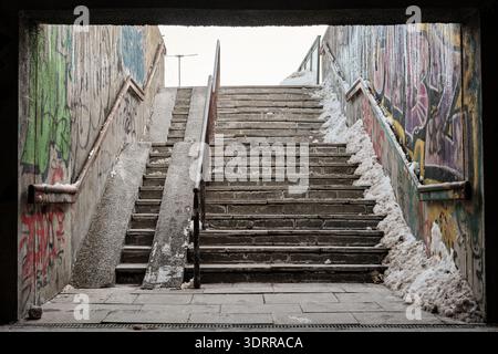 Underpass leading to the tram station in Gdansk, Poland covered with grafitti in the winter. Stock Photo