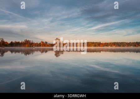 Calm water with beautiful reflections on a Bavarian lake in Germany. Stock Photo