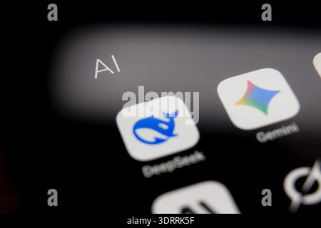 DeepSeek and Gemini application icons displayed on a smartphone screen within an AI folder, representing the competitive landscape of mobile artificia Stock Photo