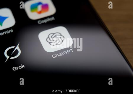 ChatGPT, Copilot, Gemini, and Grok application icons displayed on a smartphone screen, illustrating the competitive ecosystem of leading AI chatbot pl Stock Photo