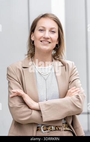 Portrait of young adult mid age businesswoman in formal dress suit outdoors. Happy confident stylish elegant business woman female person. Financial Stock Photo