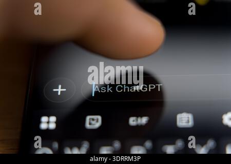 Hand typing on smartphone screen with Ask ChatGPT prompt, mobile AI assistant interface and chatbot technology concept. High quality photo Stock Photo