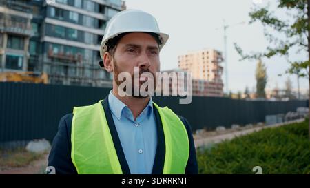 Tired exhausted builder Caucasian man engineer take of hardhat end working day middle-aged inspector real estate developer investor architect Stock Photo