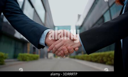 Formal handshake businessman shaking hands businesswoman close up partnership business handshaking success shake arms together female male meeting Stock Photo