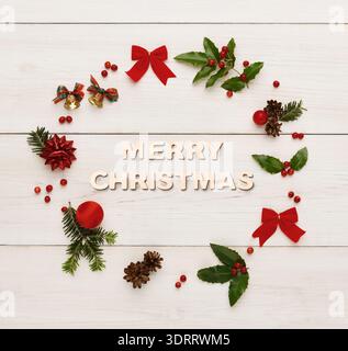 Collage of Christmas Decorations Arranged on a Wooden Background With a Festive Message Stock Photo