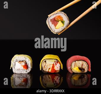 Different Types of Sushi Rolls Displayed With Chopsticks in a Collection Set Stock Photo