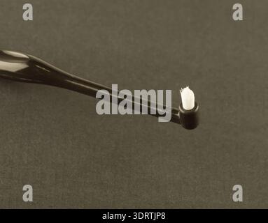 new modern toothbrush isolated on black solid background Stock Photo