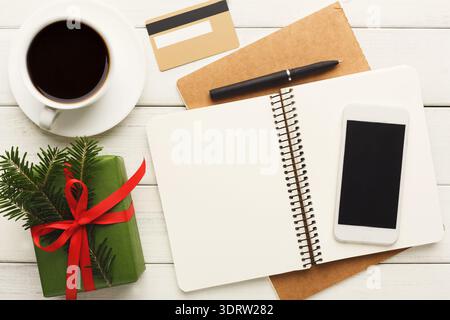 Creative Workspace Setup With Coffee, Notebook, Phone, and Gift on a Wooden Surface Stock Photo