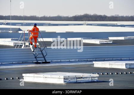 Construction worker on the top of an industrial factory - France Stock Photo