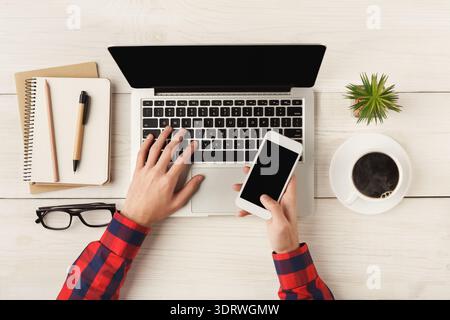 Creating a Collage With a Laptop and Smartphone on a Wooden Table in a Workspace Stock Photo