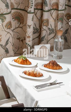Assorted croissants served in cozy cafe Stock Photo