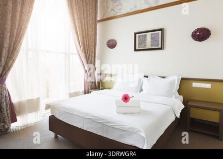 Bright Room With Bed and Flowers in a Collage of Different Home Styles Stock Photo