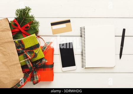 Gift Preparation With Presents and Tools for Planning on White Wooden Surface Stock Photo