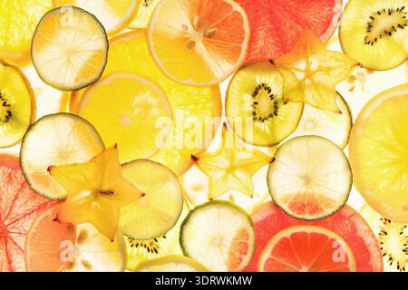 Collection of Colorful Fruit Slices Arranged in a Mosaic Pattern on a Bright Background Stock Photo