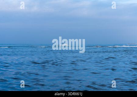 Calm Baltic Sea with Gentle Waves Under Blue Winter Sky Stock Photo