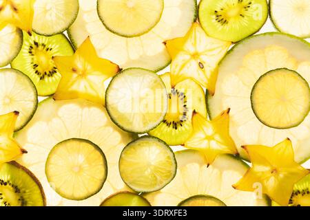 Bright Collection of Sliced Fruits Arranged in a Collage on a Light Background for Fresh Decoration Stock Photo