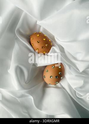 Two Easter eggs decorated with rhinestones. New design vision on Christian Easter traditions, ideas for holiday table Stock Photo