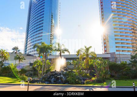 San Diego, California - December 30, 2025: Glass towers of the Marriott Marquis San Diego Marina hotel are reflected in a fountain with palm trees on Stock Photo