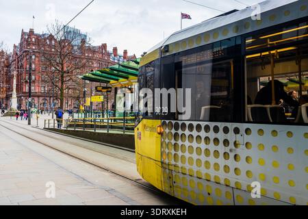 A detailed side profile of a yellow and silver Metrolink tram at a station platform showing the iconic pattern seen on 18 February 2026. Stock Photo