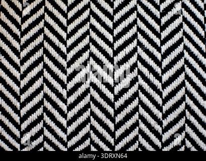 Black and white zigzag fabric texture. Striped textile close up showing detailed weave, modern pattern, and alternating lines for design backgrounds. Stock Photo