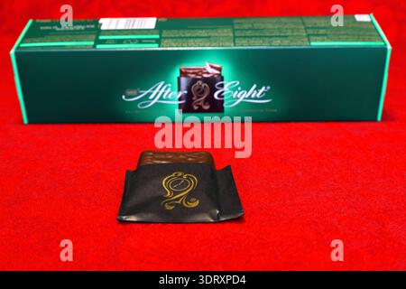 After eight candy box. Classic English mint chocolate. Red cloth as background. Stock Photo