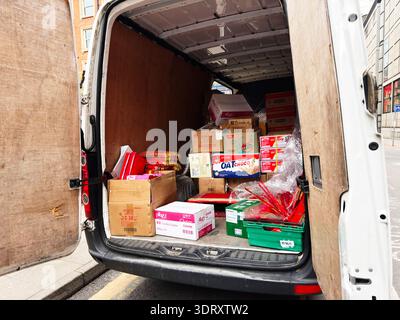 Manchester, UK - January 29, 2026: Open back of a white van filled with chinese  boxes and groceries for local delivery in Manchester UK. Stock Photo