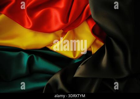 Black History Month background. Red, yellow, green colors satin silk flag draperies Stock Photo
