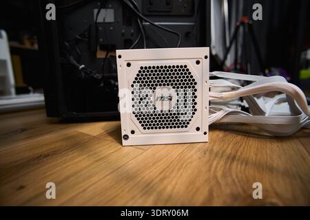 Tyumen, Russia-February 15, 2026: MSI power supply detail during assembly of a personal computer in a workspace setting Stock Photo