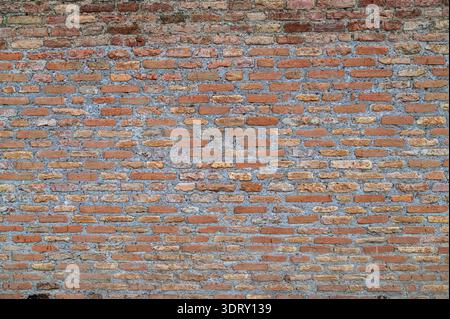 Ancient Brick Wall in Rome with Trees,,Weathered Stone, Grunge Roman wall texture with visible bricks in the historic center of Rome Stock Photo