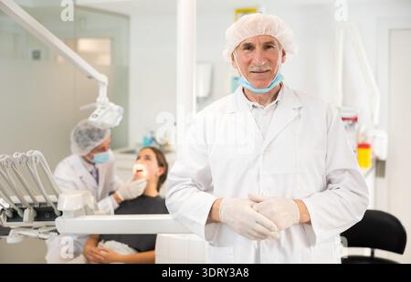 Senior man doctor is standing in dental office, clinic Stock Photo