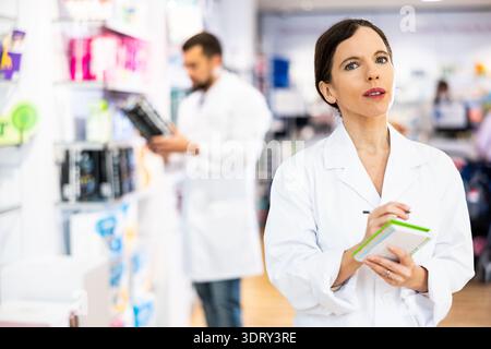 Portrait of female pharmacist working in drugstore Stock Photo