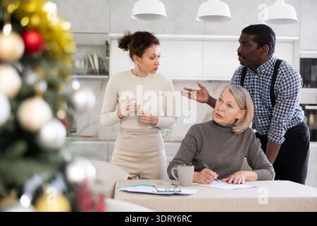 Couple discussing testament with elderly woman Stock Photo
