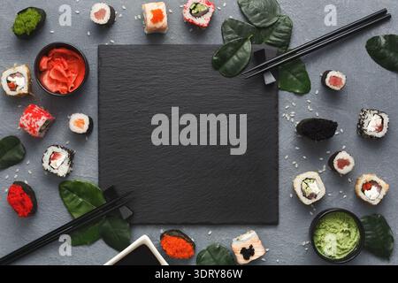 Sushi and Condiments Arranged on a Gray Surface With Empty Space for Text or Design Stock Photo