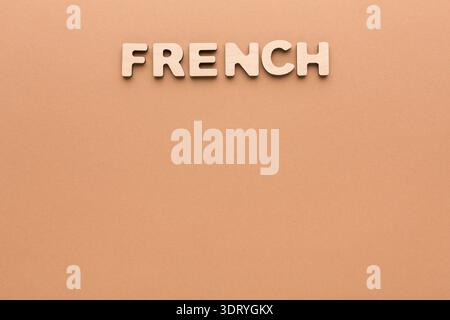 Wooden Letters Spelling French on a Simple Background With No Distractions Present Stock Photo