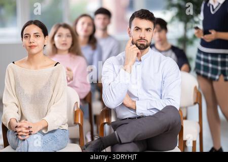 Group of young students listening during seminar in a modern classroom Stock Photo