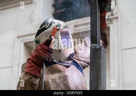 Welder working with protective gear, arc welding metal Stock Photo