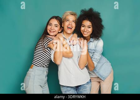 Three Friends Smile and Hug Together in a Bright Collage of Happy Moments Indoors Stock Photo