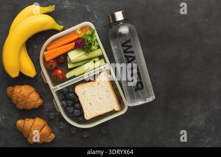 Healthy Lunch Box With Fruits and Vegetables Arranged in a Neat Collection Stock Photo