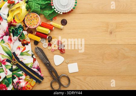 Collage of Sewing Tools and Materials on a Wooden Surface Arranged in Various Positions Stock Photo